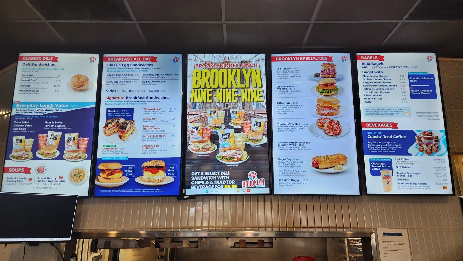 Five digital menu displays installed above a restaurant counter