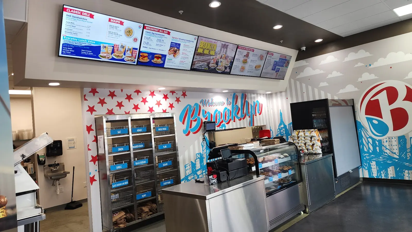 Wide view of digital menus in a Brooklyn Water Bagel restaurant