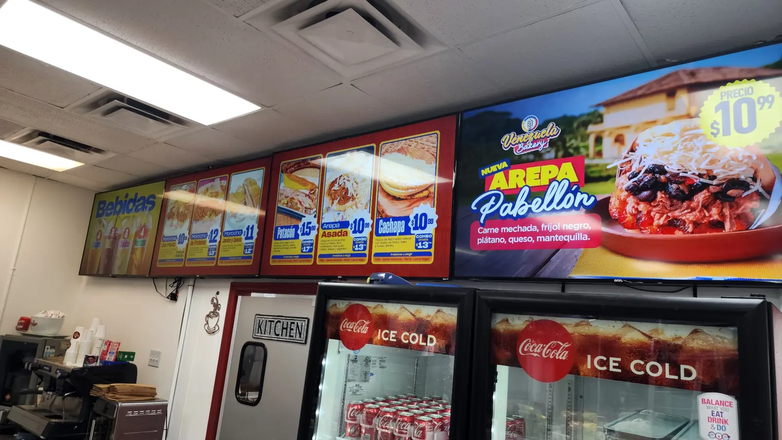 Digital food menus and promotional display at Venezuela Bakery